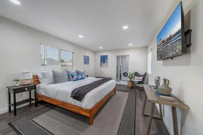 a bedroom with a bed and a desk and a tv at Bellaire in Garnsey