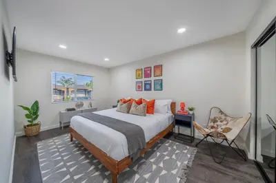 a bedroom with a large bed and a chair at Bellaire in Garnsey