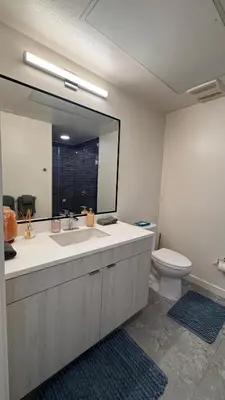 a bathroom with a sink and a toilet and a mirror at Luxury Walk of Fame Studio in Los Angeles