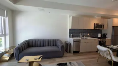a living room with a couch and a kitchen at Luxury Walk of Fame Studio in Los Angeles