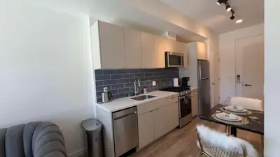 a kitchen with white cabinets and a counter top at Luxury Walk of Fame Studio in Los Angeles