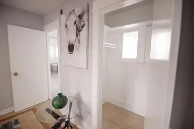 a white hallway with a glass table and a window at Private Room in East Hollywood in Los Angeles