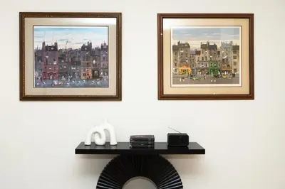 two framed pictures on a wall with a table at Ocean 2min, Romantic Bath, Cinema, Pool, Arcade in Marina del Rey