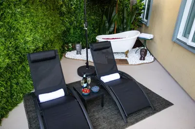 two chairs and a table on a patio at Ocean 2min, Romantic Bath, Cinema, Pool, Arcade in Marina del Rey