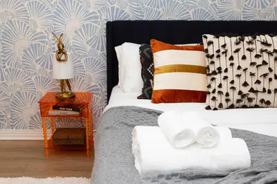 a bedroom with a bed with towels on it at Ocean 2min, Romantic Bath, Cinema, Pool, Arcade in Marina del Rey
