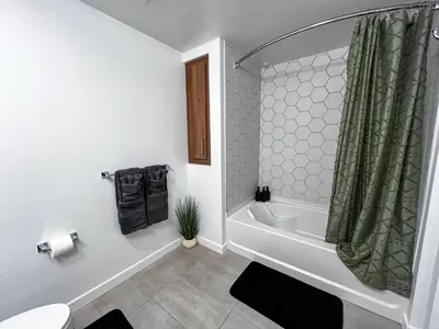 a bathroom with a tub and a toilet and a shower at Modern Cosmopolitan APT Mid Hollywood with Free Parking 10mins to Universal Studios in Los Angeles