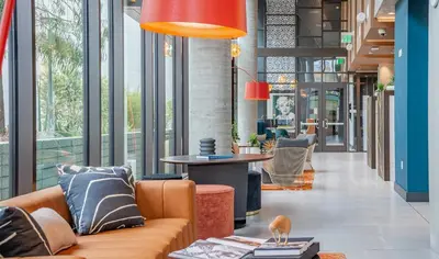 a lobby with a couch and a table at Modern Cosmopolitan APT Mid Hollywood with Free Parking 10mins to Universal Studios in Los Angeles