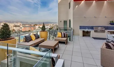 an apartment balcony with a view of a city at Mid Century With Pool GYM and Parking 10min to Cedars in Los Angeles