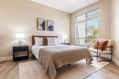 a bedroom with a bed and a window and a chair at 2BD Marina Condo Near Venice Beach, Pool & Free Parking in Los Angeles