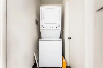 a washer and dryer sitting on top of a refrigerator at Spacious 4 bedroom home by Melrose and 10 minutes to Hollywood Walk of Fame in Los Angeles