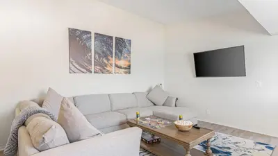 a living room with a couch and a table at Beach Retreat with Oceanfront Balconies Direct Beach Access Pacific Coast Outlook by AvantStay in Malibu Beach