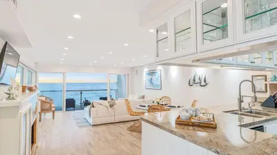 a kitchen and living room with a view of the ocean at Beach Retreat with Oceanfront Balconies Direct Beach Access Pacific Coast Outlook by AvantStay in Malibu Beach