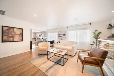 a living room with a couch and chairs and a table at Bay Breeze Hideaway in Lawndale