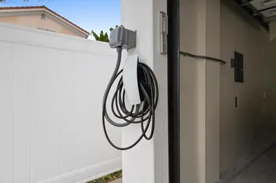 a hose is hooked up to the side of a fence at Bay Breeze Hideaway in Lawndale