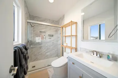 a bathroom with a shower and a sink and a toilet at Bay Breeze Hideaway in Lawndale