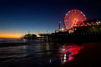 a pier with a ferris wheel on the beach at night at Exquisite 2BDRM in Heart of MDR King Bed in Los Angeles