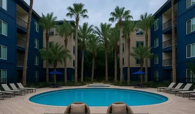 a swimming pool in a courtyard with palm trees at Exquisite 2BDRM in Heart of MDR King Bed in Los Angeles