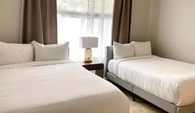 two beds in a room with a window at Exquisite 2BDRM in Heart of MDR King Bed in Los Angeles