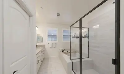 a white bathroom with a shower and a sink at Modern 3BR Home Gated Community in Bakersfield