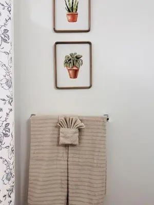 a towel rack with three pictures on a wall at The Hollywood loft FREE Parking in Los Angeles
