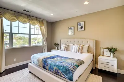 a bedroom with a large bed and a window at 3 Mi to Disneyland Home with Hot Tub and Game Room in Anaheim