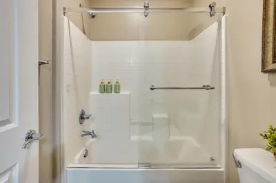 a bathroom with a shower with a glass door at 3 Mi to Disneyland Home with Hot Tub and Game Room in Anaheim