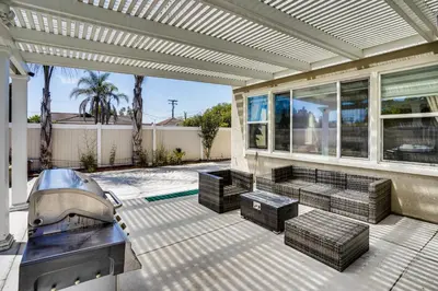 a house with a swimming pool on a patio at 3 Mi to Disneyland Home with Hot Tub and Game Room in Anaheim