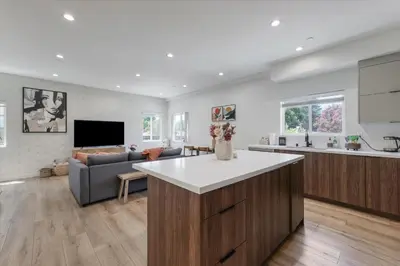 a kitchen and living room with a couch and a table at LA Haven Spacious Townhome in Sherman Oaks Community Hospital Heliport