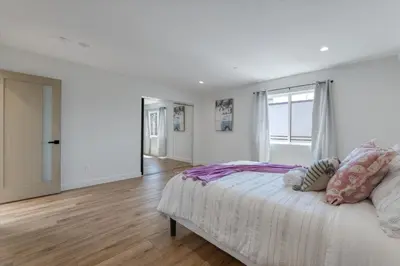 a white bedroom with a bed and a window at LA Haven Spacious Townhome in Sherman Oaks Community Hospital Heliport