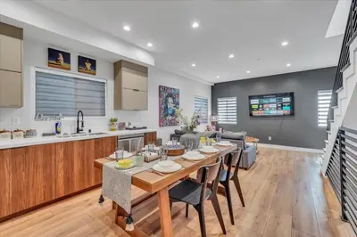 a dining room and kitchen with a table and chairs at LA Haven Spacious Townhome in Sherman Oaks Community Hospital Heliport