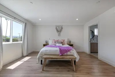 a bedroom with a bed and a large window at LA Haven Spacious Townhome in Sherman Oaks Community Hospital Heliport