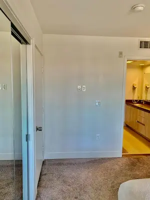 an empty room with a door leading to a kitchen at Western Sierra Vista in Los Angeles