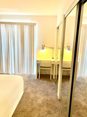 a hotel room with a mirror and a bed at Western Sierra Vista in Los Angeles
