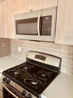 a stove top oven in a kitchen with a microwave at Western Sierra Vista in Los Angeles