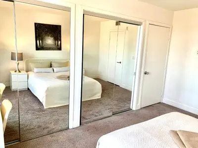 a bedroom with a mirror and a bed at Western Sierra Vista in Los Angeles