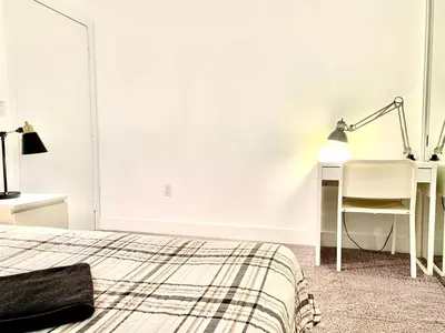 a bedroom with a bed and a desk and a lamp at Western Marathon in Los Angeles