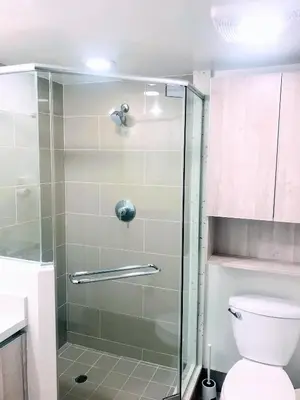 a bathroom with a glass shower with a toilet at Western Marathon in Los Angeles