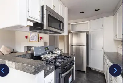 a kitchen with a stove top oven next to a refrigerator at Desert View in Victorville