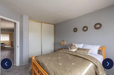 a bedroom with a large bed with two pictures of the room at Desert View in Victorville