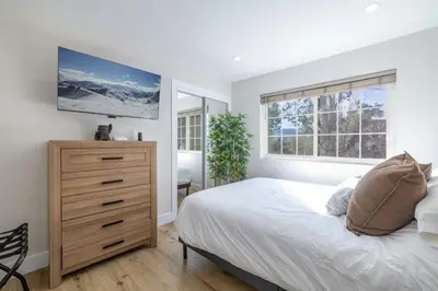a bedroom with a bed and a dresser and a window at Moonlight Ridge Jacuzzi, Gated, EV Charge, Cent AC in Big Bear City Airport