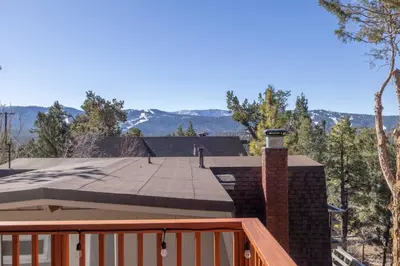 a roof of a house with a view of the mountains at Moonlight Ridge Jacuzzi, Gated, EV Charge, Cent AC in Big Bear City Airport