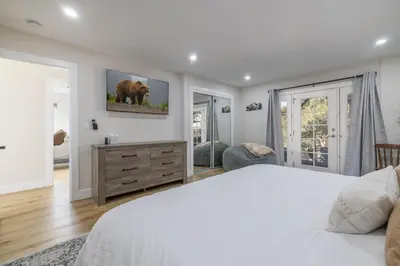 a bedroom with a white bed and a television on the wall at Moonlight Ridge Jacuzzi, Gated, EV Charge, Cent AC in Big Bear City Airport
