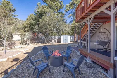 a patio with chairs and a fire pit on a house at Moonlight Ridge Jacuzzi, Gated, EV Charge, Cent AC in Big Bear City Airport