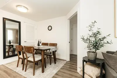 a dining room and living room with a table and chairs at Cozy 2BD apartment in Los Angeles