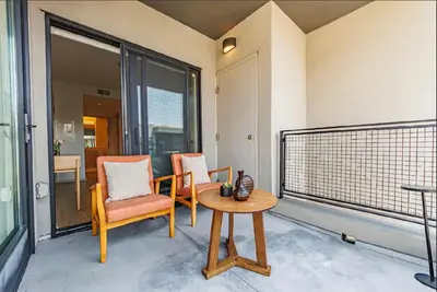 a room with two chairs and a table on a balcony at Beautiful Apartment in Hollywood in Los Angeles