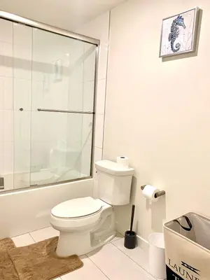 a bathroom with a toilet and a glass shower at Luxury Hollywood Stay Beautiful 2Beds2Baths in Los Angeles