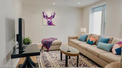 a living room with a couch and a deer on the wall at Modern Boutique Living in Culver City in Los Angeles