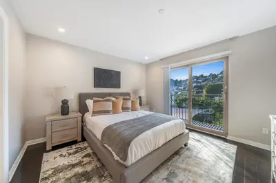 a bedroom with a bed and a large window at Spacious Hollywood Private Villa with 7 Bedrooms and Pool in Los Angeles
