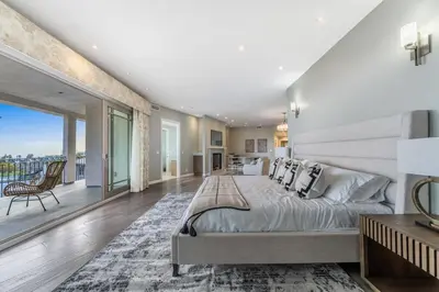 a bedroom with a large bed and a balcony at Spacious Hollywood Private Villa with 7 Bedrooms and Pool in Los Angeles