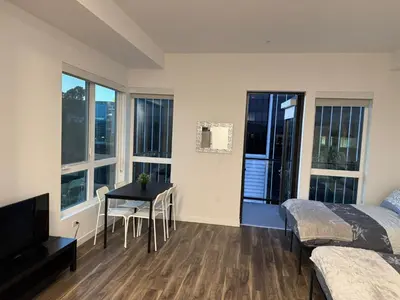 a bedroom with a desk and a bed and a table at Vine & Sunset Loft Free Parking and WIFI in Los Angeles